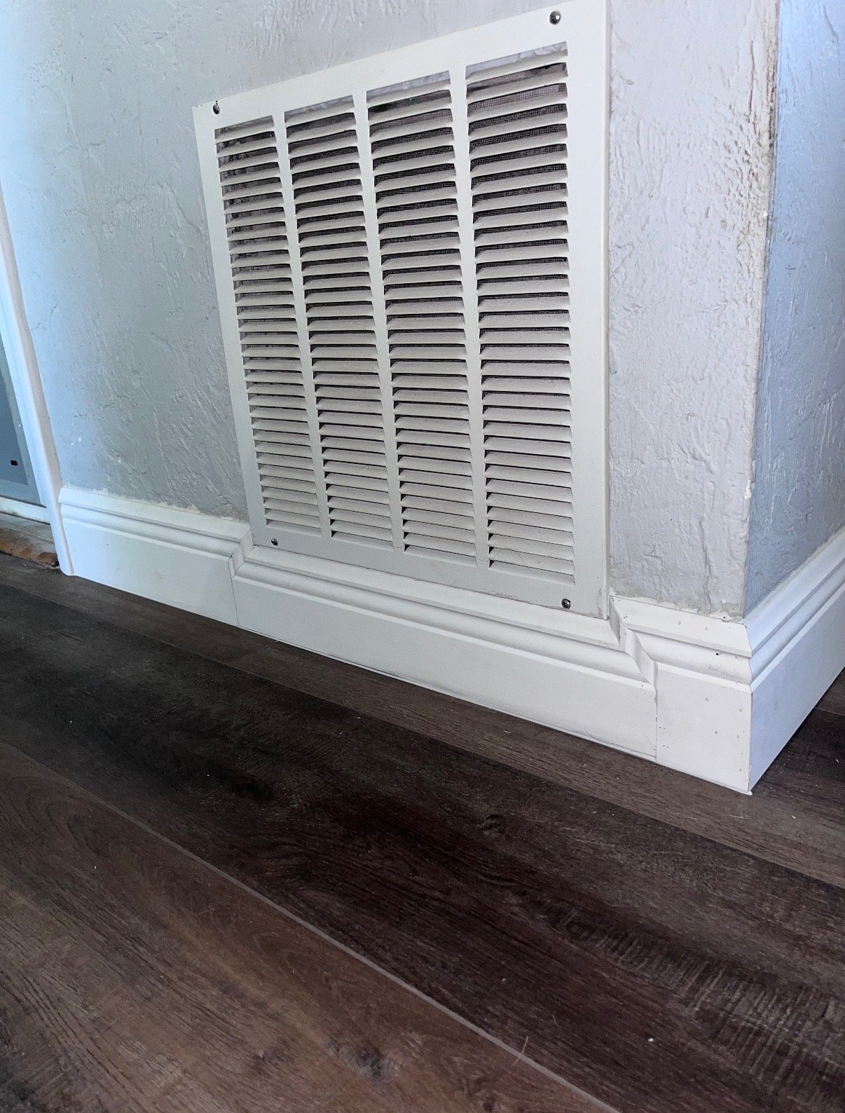 Custom baseboard trim work around a floor vent